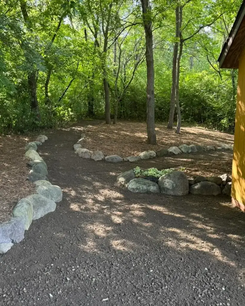 Pathway through wooded area with stone edging in Lakeville, MN