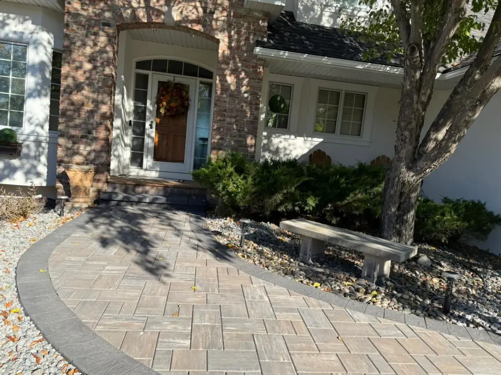 Front entrance with paver walkway and decorative plants in Lakeville, MN